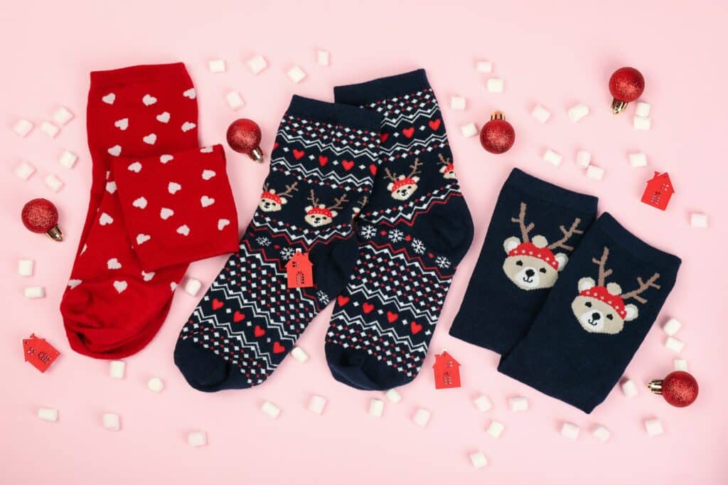 Christmas composition with socks on pink background